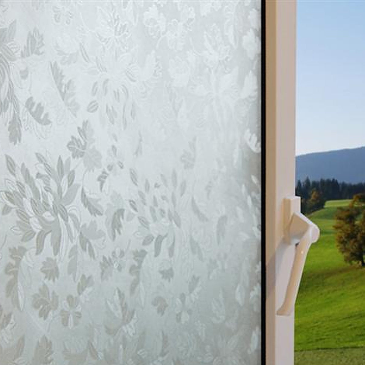 Flowers and Leaves window film on a window, with clear glass beside it
