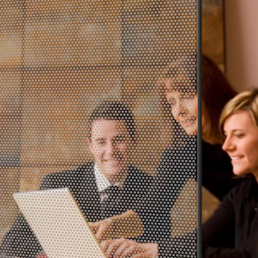 Silver Honeycomb window film on a window, with clear glass beside it