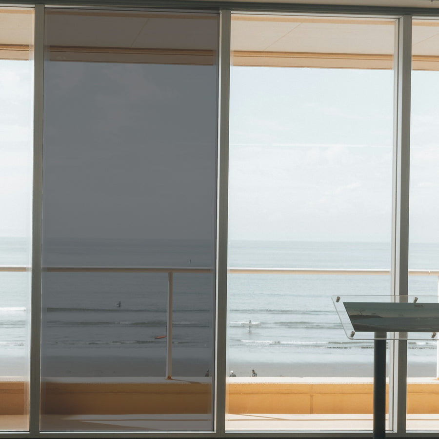 Simulated: Solar Gard Silver Window Film, Silver 20% Dark, on the left window panel next to clear glass