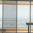 Simulated: Solar Gard Silver Window Film, Silver 50% Light, on the left window panel next to clear glass