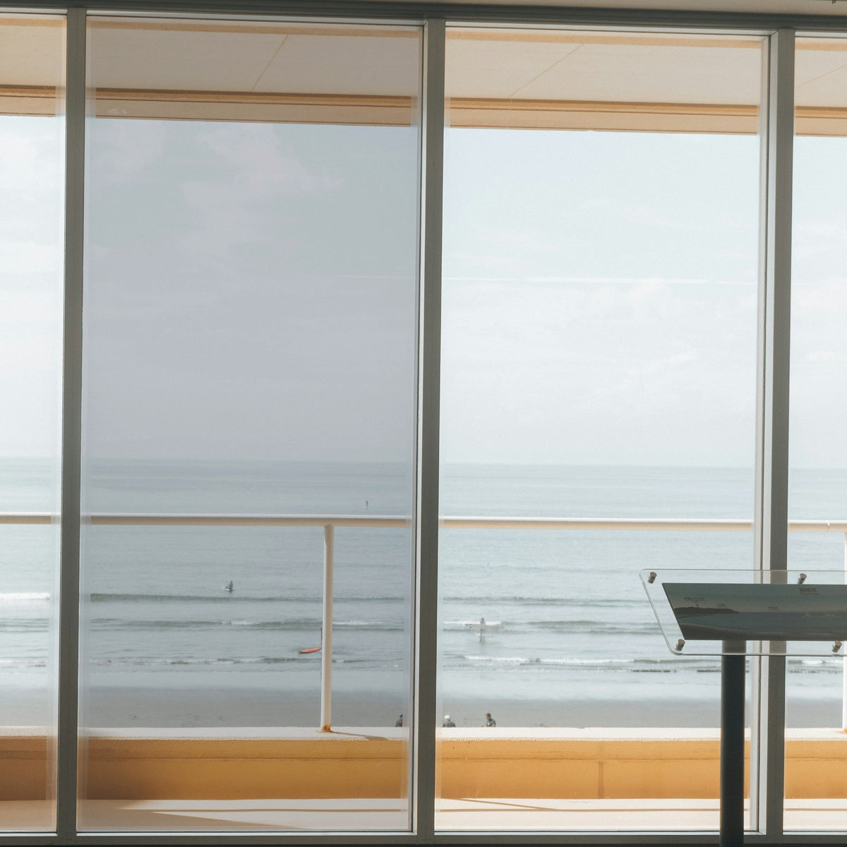Simulated: Solar Gard Silver Window Film, Silver 50% Light, on the left window panel next to clear glass