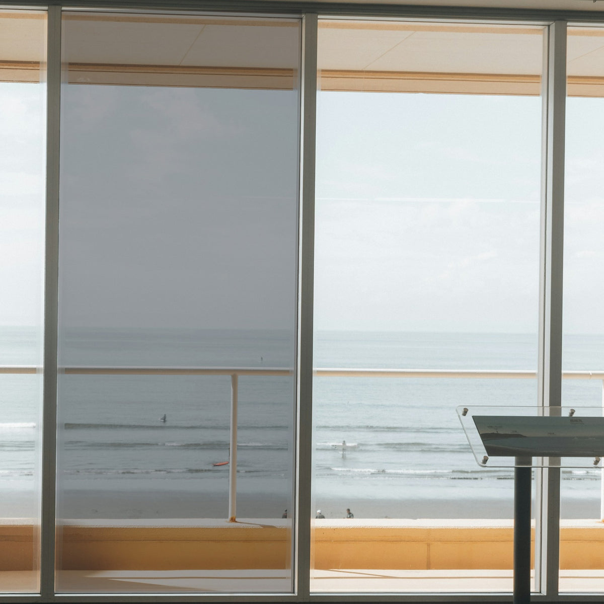 Simulated: Solar Gard Silver Window Film, Silver 35% Medium, on the left window panel next to clear glass