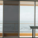Simulated: Solar Gard TrueVue Window Film, TrueVue 15% Dark, on the left window panel next to clear glass