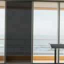 Simulated: Solar Gard TrueVue Window Film, TrueVue 5% Very Dark, on the left window panel next to clear glass