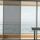 Simulated: Solar Gard TrueVue Window Film, TrueVue 30% Medium, on the left window panel next to clear glass
