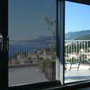 Simulated: SunTek Silver, 20% - Dark, on the left sliding door pane next to clear glass