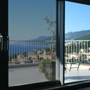 Simulated: SunTek Symphony Neutral, 25% - Dark, on the left sliding door pane next to clear glass