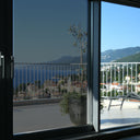 Simulated: SunTek Symphony Neutral, 15% - Very Dark, on the left sliding door pane next to clear glass